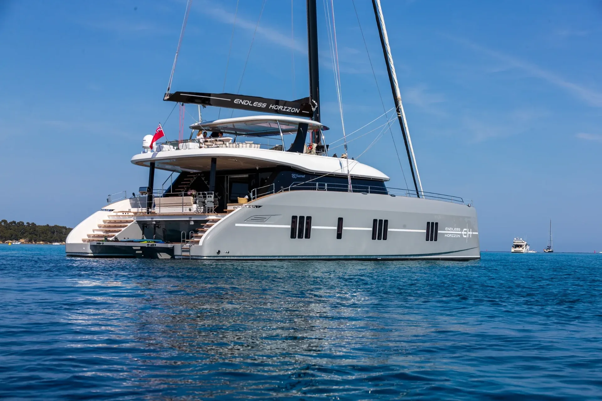 Endless Horizon II at anchor with the swim platform lowered and toys staged aft