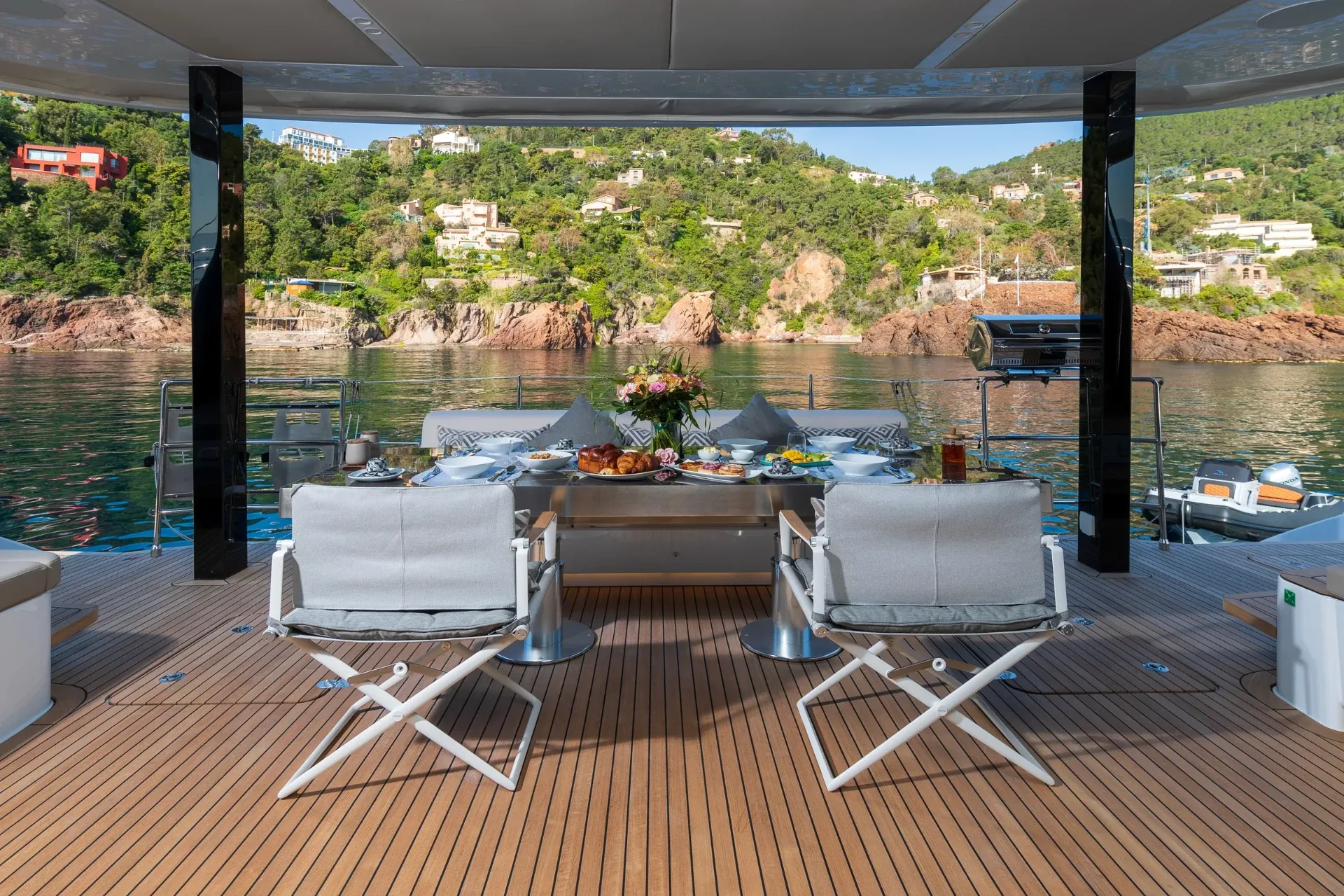 Aft deck table set for breakfast facing the red rocks of the Esterel