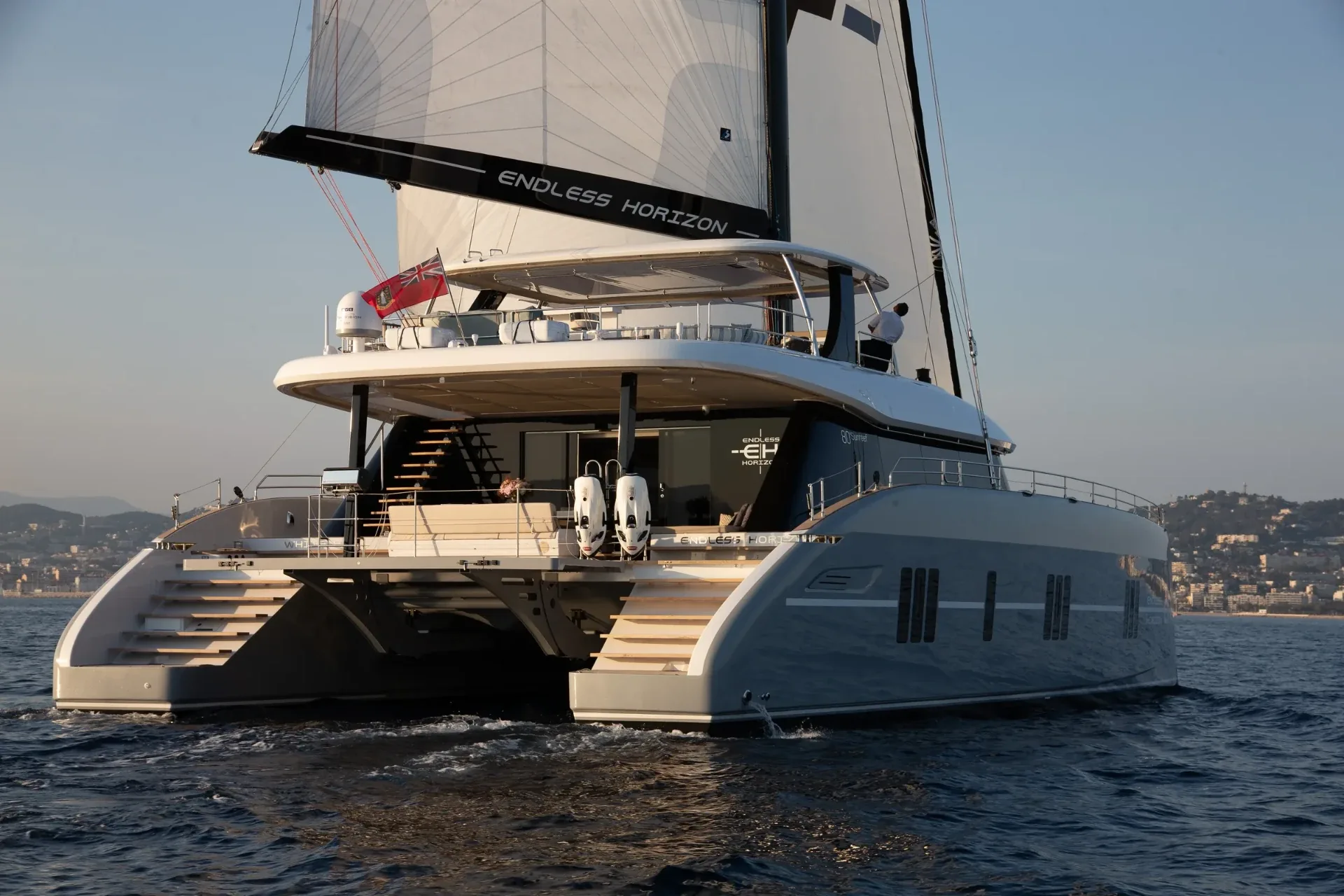 Aft quarter view showing the flybridge, cockpit and boarding stairs under sail