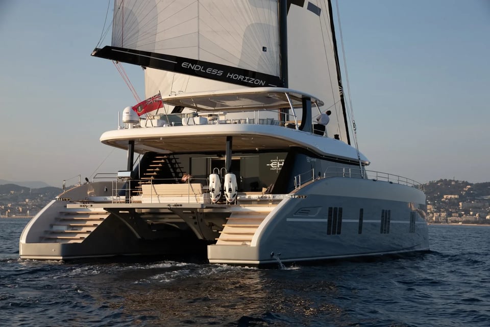 Aft quarter view showing the flybridge, cockpit and boarding stairs under sail