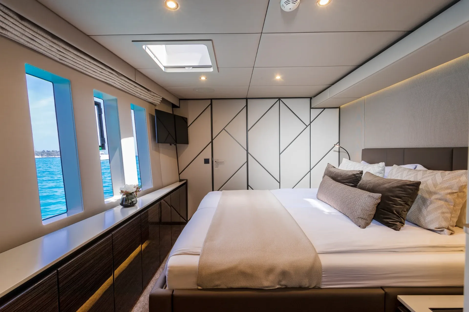 Mid-ship guest cabin finished in wenge and bleached oak aboard the Sunreef 80