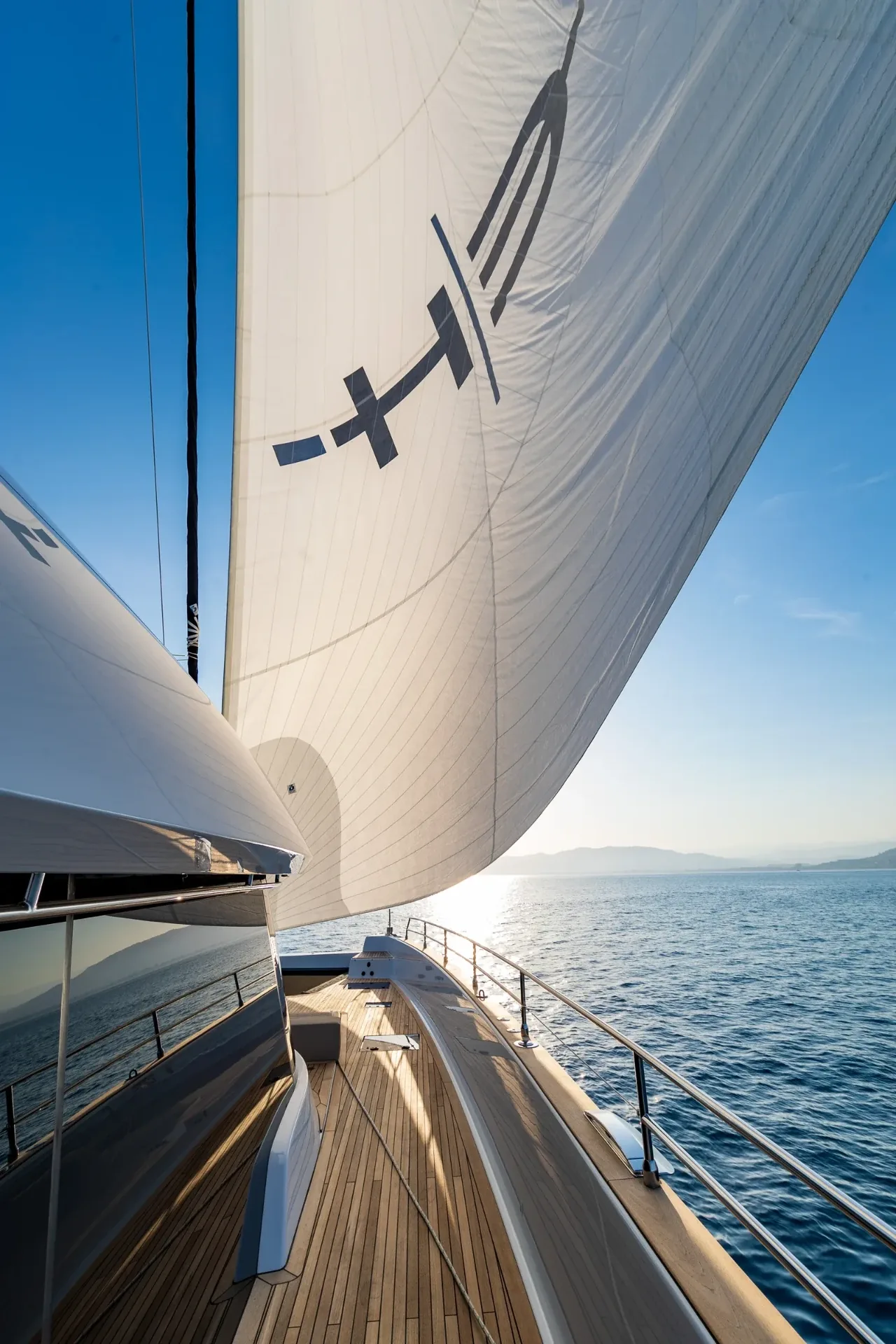 Side deck looking forward beneath the mainsail carrying the EH mark