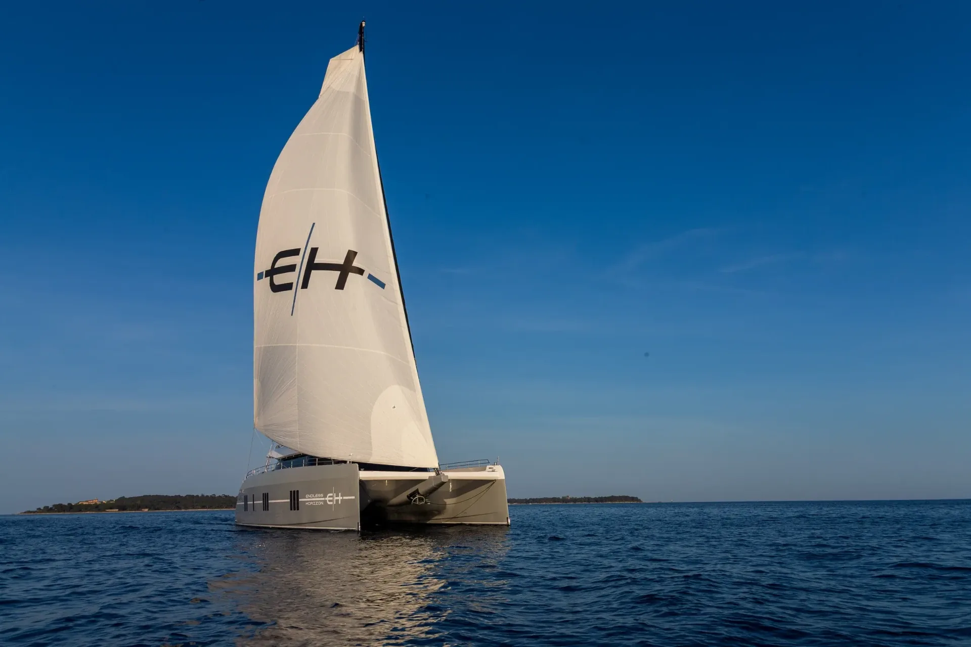 The EH mainsail set against deep blue water and sky