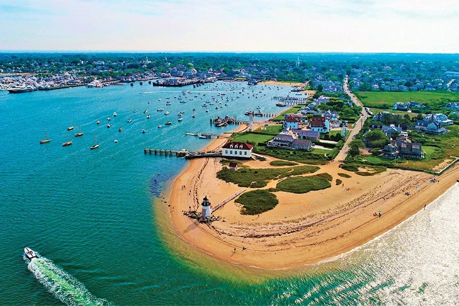 Aerial of Brant Point Light and Nantucket harbour crowded with moored boats in summer