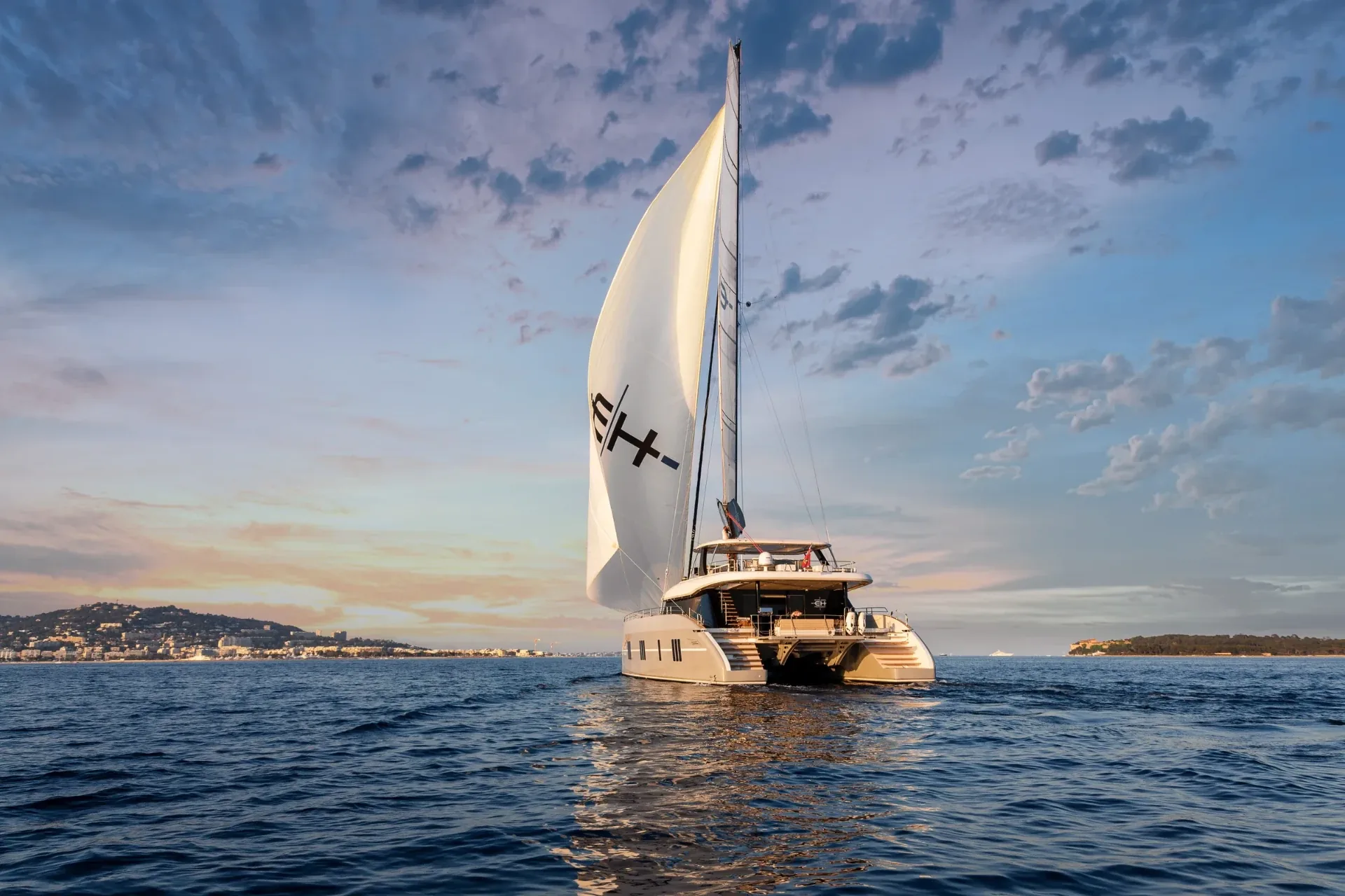 Endless Horizon II sailing at dusk under a cloud-streaked sky off the Riviera