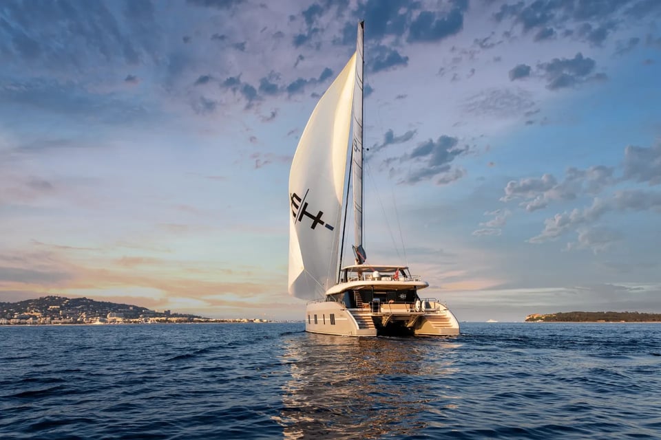 Endless Horizon II sailing at dusk under a cloud-streaked sky off the Riviera