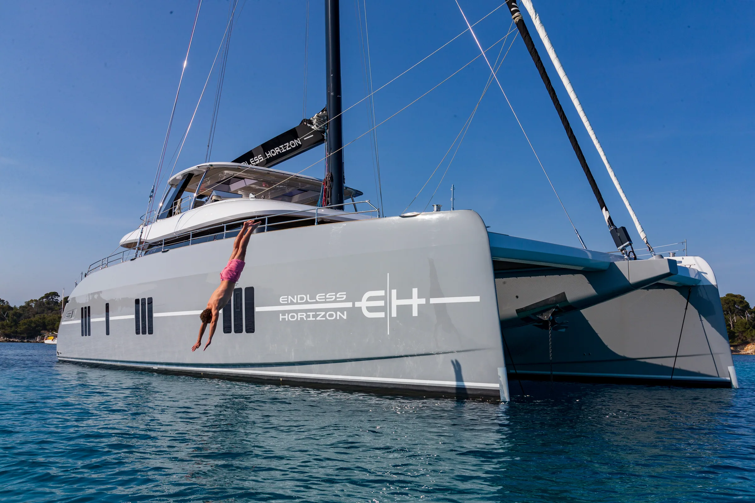 A guest diving from the bow of Endless Horizon II into open water