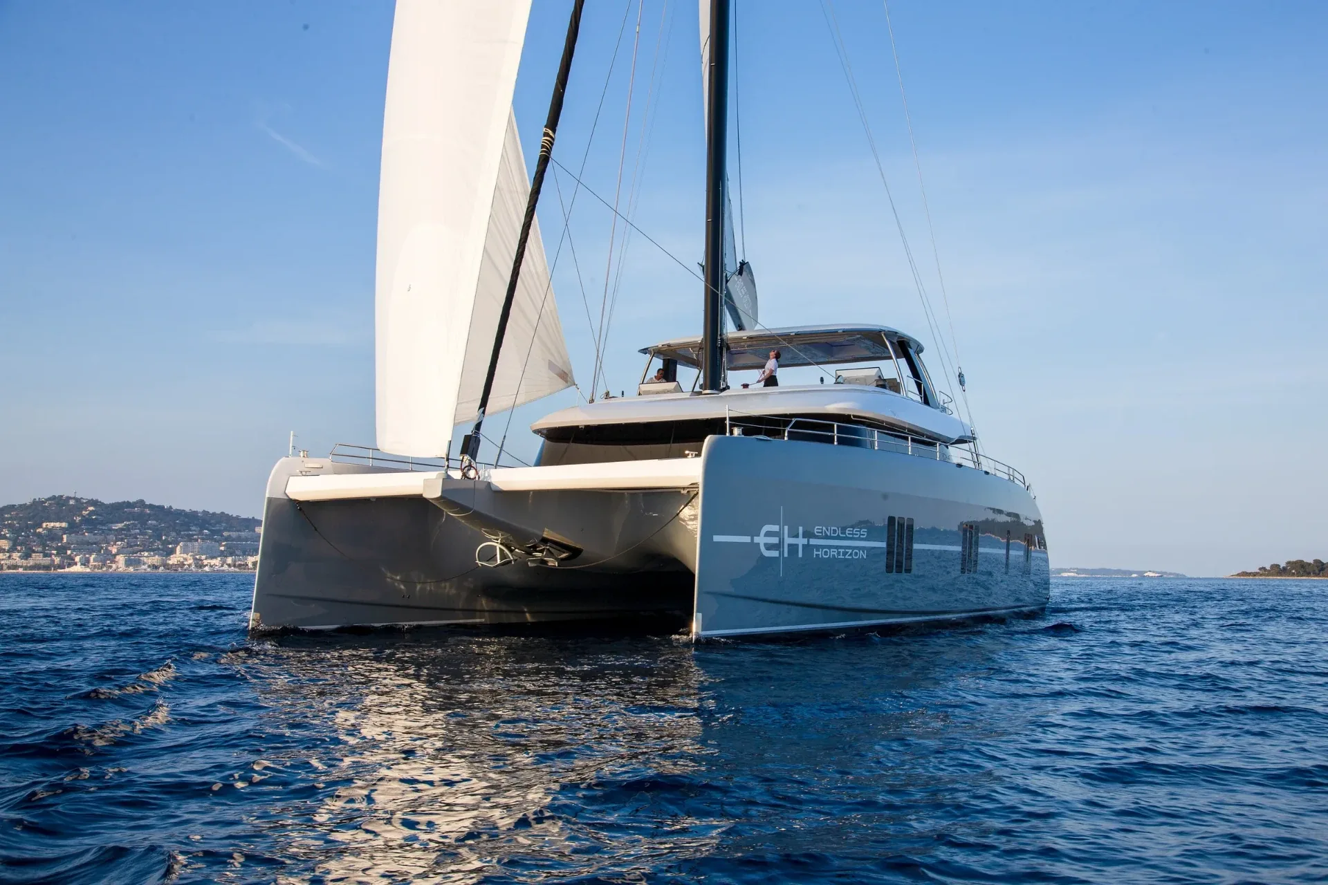 Bow quarter view of Endless Horizon II sailing past the Cannes coastline