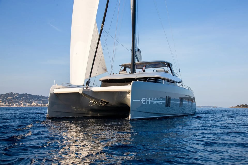 Bow quarter view of Endless Horizon II sailing past the Cannes coastline