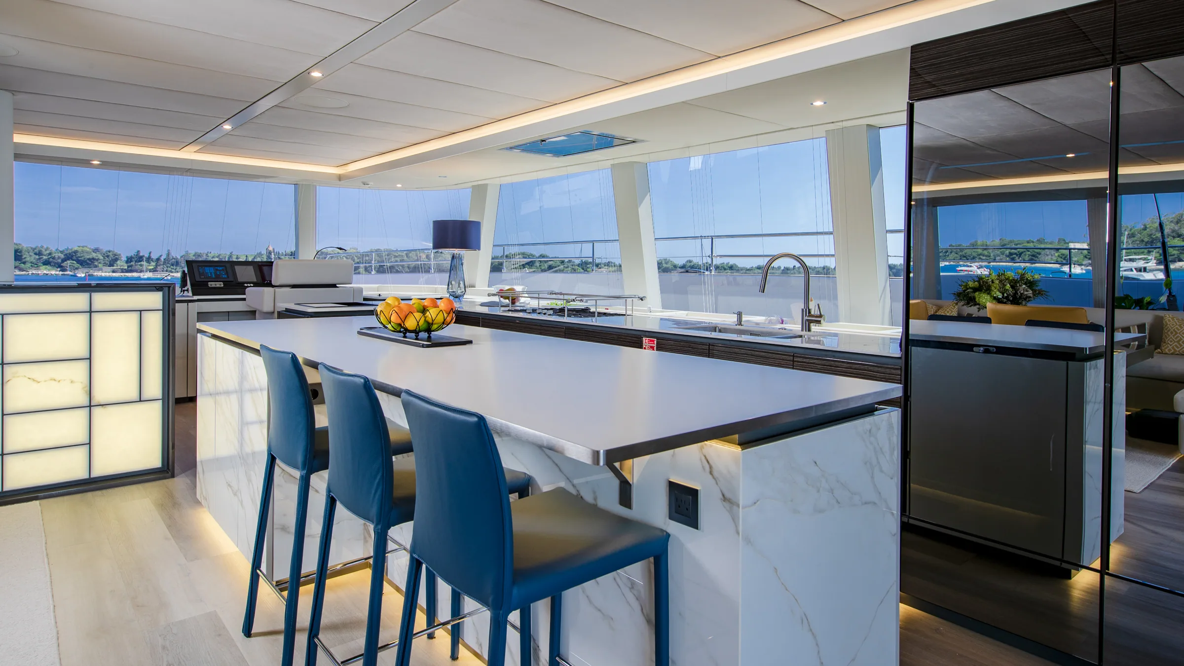 Galley island with bar seating in the salon of the Sunreef 80